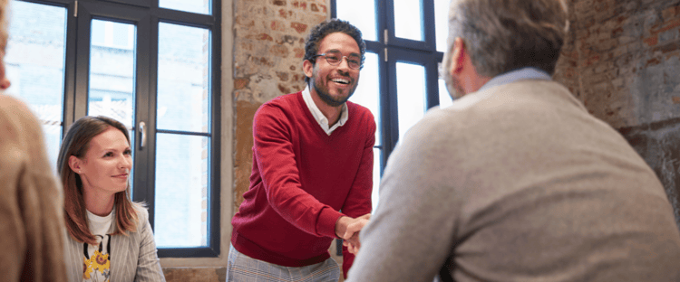 Business owner shaking hands after successfully managing and resolving a dispute
